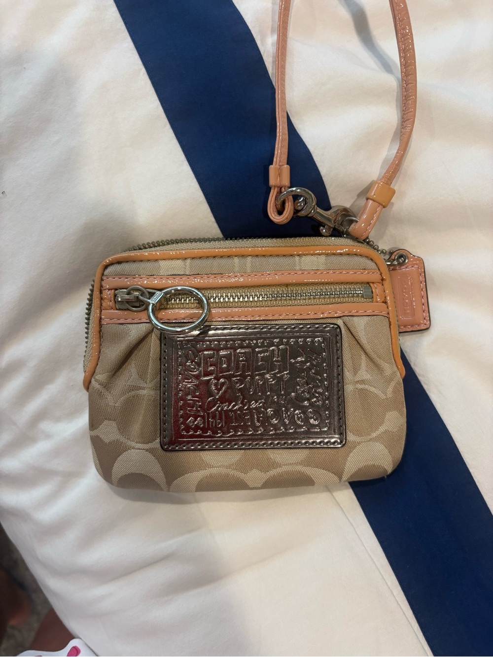 Coach Beige Signature Canvas Wristlet with Peach Trim and Metallic Patch